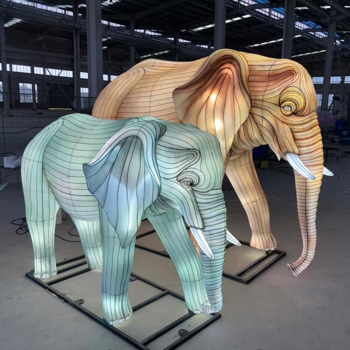 Elephant Parade painted adult and juvenile elephant lanterns